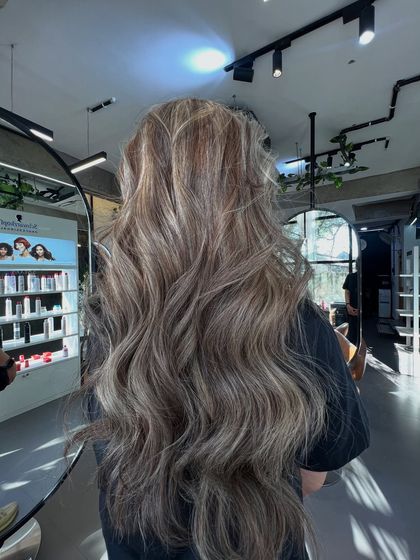 The light catches the cool tones in this ash blonde balayage beautifully, showing off the complexity of the color.
