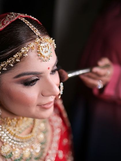 A behind the scenes shot of me adding the final touches. Applying a soft powder ensures the makeup is set perfectly for hours of photography and celebration. This shows the care I take in the final steps of the bridal makeover.