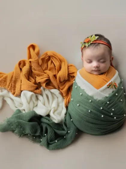 Celebrating Independence Day with the youngest patriot. This newborn is wrapped in the colors of our flag, symbolizing hope for the future.