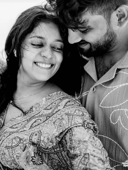 A tender black and white close-up, highlighting the soft smiles and gentle connection between the couple.