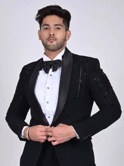 The same model, showcasing the fit and silhouette of our tailored black tuxedo.