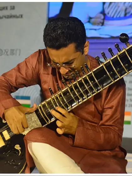 A close-up shot showing the intricate handwork involved in playing a complex composition during a diplomatic event.