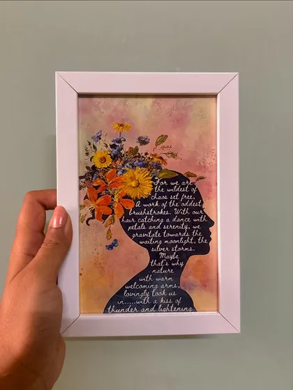 A frame that empowers. This piece features a silhouette filled with a beautiful poem, surrounded by a watercolor floral design, celebrating the strength and wildness of nature.