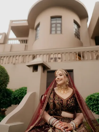 A happy, seated portrait of the bride, her smile radiant, her traditional attire looking magnificent.