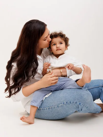 A mother's gentle kiss is a moment of pure tenderness. I focus on capturing these quiet, intimate connections during our family photoshoots.