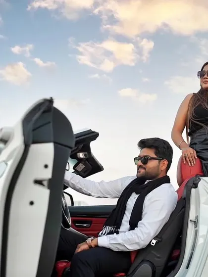 A stylish portrait of the couple with their convertible. This image has a high-fashion, editorial feel, perfect for a glamorous Dubai pre-wedding album.