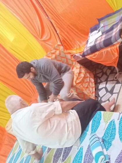 A member of our team provides hands-on therapy to a patient at our community service camp. We believe everyone deserves access to quality care to live a pain-free life.