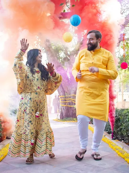 The energy of a Haldi ceremony is unmatched. I use elements like colored smoke to add a dynamic and celebratory feel to the couple's entrance, making for vibrant, fun-filled photographs.