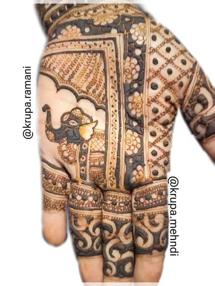 A classic Indian mehndi design with a beautifully decorated elephant as the centerpiece. The bold lines and detailed patterns are signatures of this style.