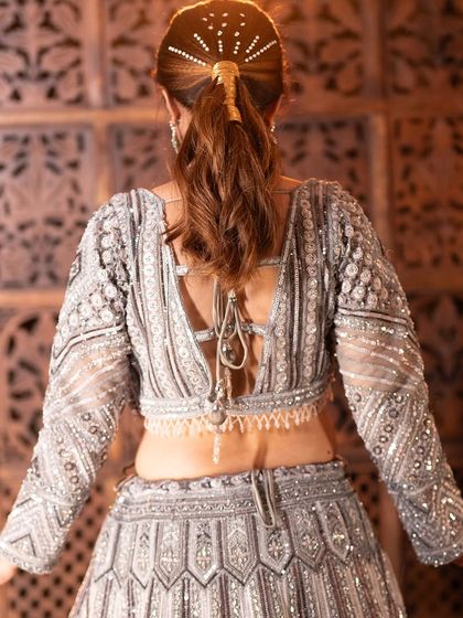 A complete look at my silver-grey geometric lehenga from a professional shoot. You can see the intricate details, the stylish back, and how it moves. It's a true work of art.