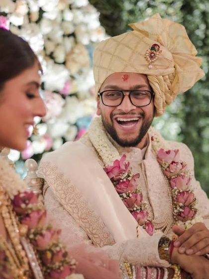The groom's infectious laughter during the wedding ceremony, a genuine moment of happiness that we love to capture.