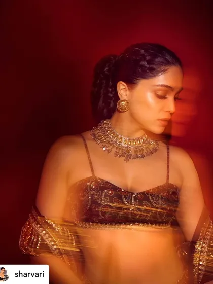 An artistic, motion-blur shot of Sharvari. This image captures the mood and glamour of the look, highlighting the shimmering details of the makeup.