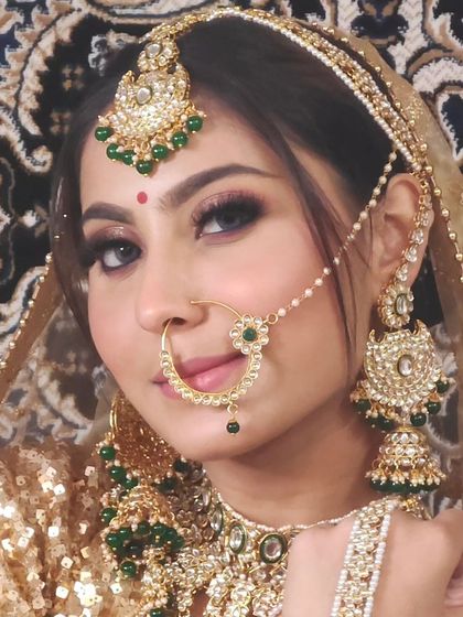 Another view of the bride in the golden sequin lehenga, showing the beautiful jhumkas and nath.