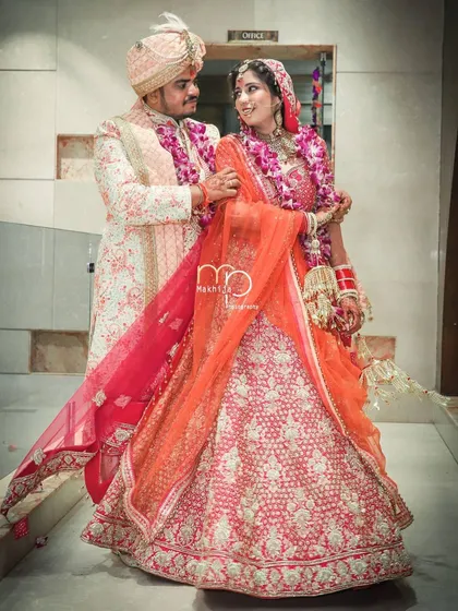 A full-length portrait of the couple in their stunning wedding outfits. I make sure to capture these classic shots that you will cherish for a lifetime, showcasing your complete bridal and groom look.