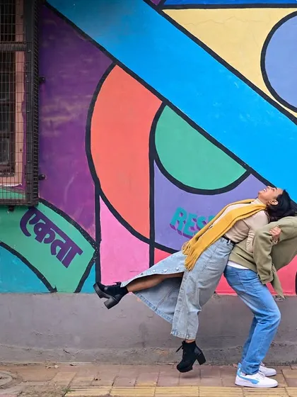 A playful lift against a vibrant, graphic wall. We capture the fun and carefree dynamic between couples during their pre-wedding session.