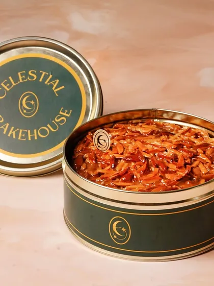 Our tins aren't just for layered desserts. Here is our Honey Almond Crunch Cake, packed snugly in a Cosmic Tin for safe travel and gifting.