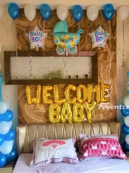 A 'Welcome Baby' boy bedroom decoration with blue and white balloon columns and themed foil balloons.