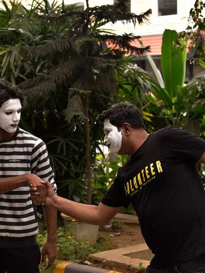 A mime artist interacts with a volunteer, demonstrating the power of connection without words. Our events are filled with these beautiful, spontaneous moments.