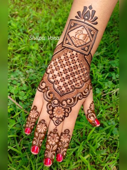 A close-up of a beautiful design featuring a swan in a frame, set against a lush green background.