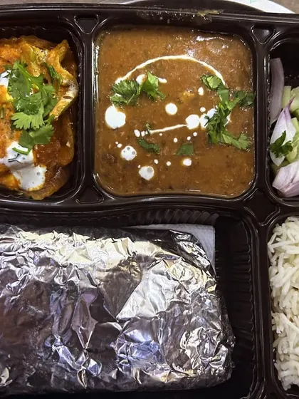 Another premium thali with Dal Makhni and Kadai Paneer, complete with rice, roti, and salad. This is a perfect meal for a special occasion.