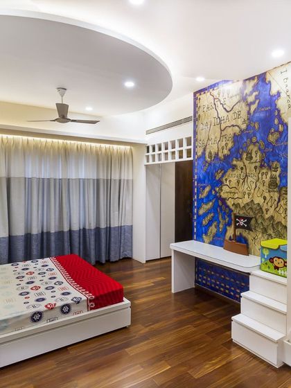 A wider view of the themed bedroom, showing how the bunk bed integrates with a study desk. It’s a perfect example of combining playfulness with practicality.
