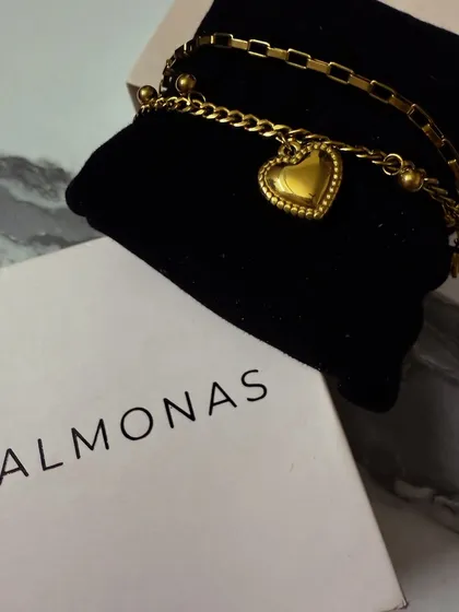 A close-up of the Palmonas heart charm bracelet, highlighting the intricate details and craftsmanship of the piece.