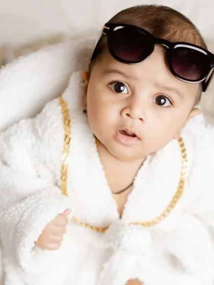 A classic cool pose from our little millionaire, looking sharp in his sunglasses and bathrobe.
