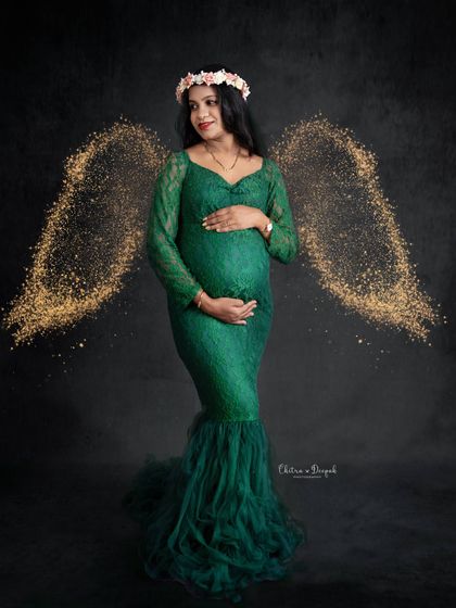 An angelic touch. We added sparkling wings to this portrait of a mom-to-be in a green lace gown, creating a celestial and magical fine-art piece.