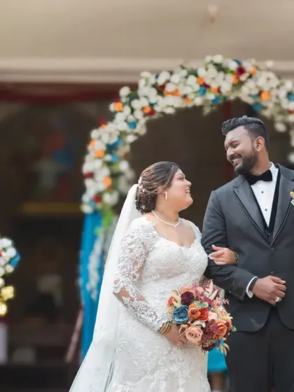 The joy on their faces says it all. A beautiful, candid shot of the couple walking out of the church, beaming with happiness after their wedding ceremony.