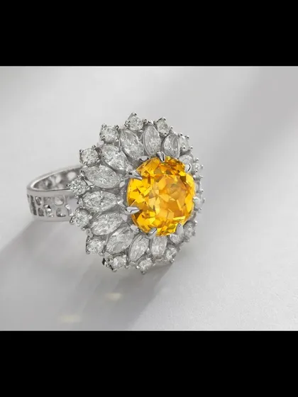 A floral-inspired statement ring featuring a vibrant round yellow gemstone at its center, encircled by marquise-cut diamonds. This image showcases my ability to balance complex designs and capture the unique character of colored gemstones for catalogue and campaign use.