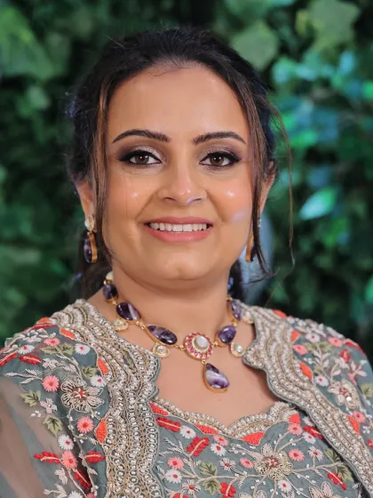 A close-up of the engagement makeup, showing the detail of the coral-toned smokey eye and the flawless, glowing skin.