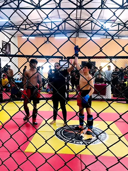 A view from outside the cage as one of our warriors is declared the winner. You can see the determination and spirit it takes to compete in youth MMA.