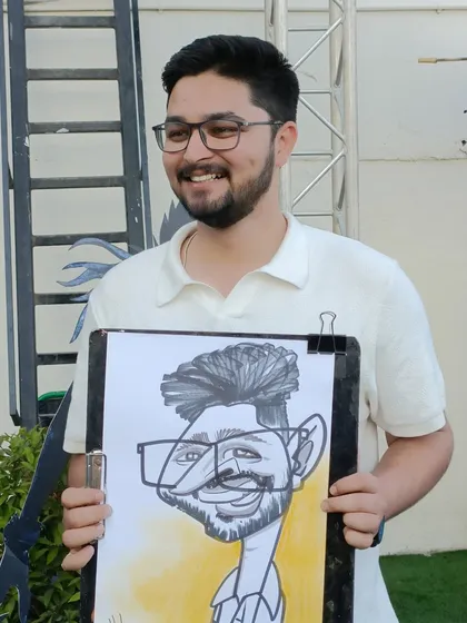 A smiling guest with his caricature from the event at KOPA Mall.