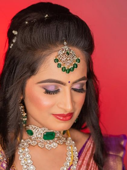 A close-up of the eye makeup for this reception look. The blend of purple and silver shimmer on the lids creates a captivating effect, perfect for an evening event.