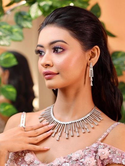 A real-life Barbie. This glamorous reception look features a beautiful pink smokey eye and a flawless base, making our bride look like a dream.