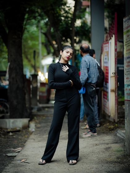 This pose, with one hand on the hip, conveys confidence. It's a great power pose for a strong portrait.