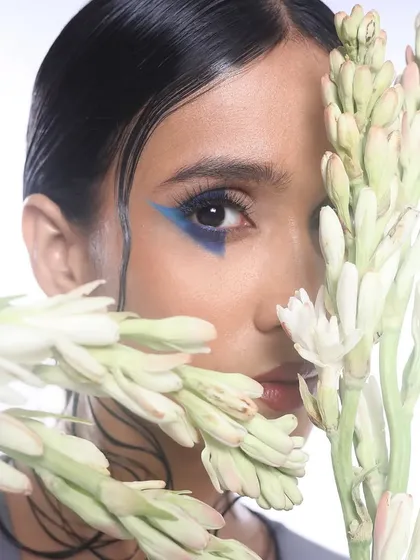 It's a blue feeling. Here, I created a bold, geometric blue graphic liner, paired with a wet-look hairstyle and dewy skin for a modern, artistic concept.