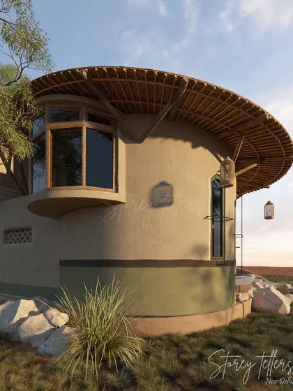 The curved form of this building is a recurring motif at Driftwood, softening its presence in the natural environment. The large window and thatched roof are characteristic of the resort's unique architectural language.