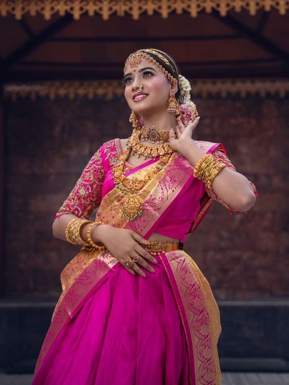 The full look, showing how the half-saree is draped elegantly. The makeup, hair, and outfit all come together to create a look that is both traditional and youthful.