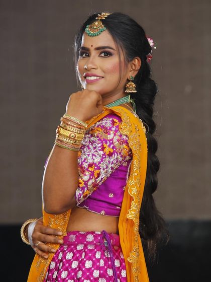 A side profile showing off the braided hairstyle and the glowing makeup. This is a great look for a wedding guest or bridesmaid.