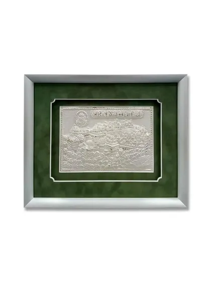 The full view of the framed silver artwork. The combination of the silver metal frame and the deep green mat creates a sophisticated and reverent presentation for this special piece.