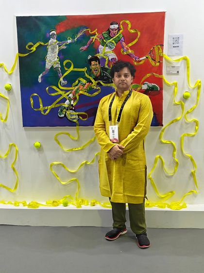 Artist Kumar Avinash stands with his vibrant, three dimensional tennis painting at our World Art Dubai booth. We design our exhibition spaces to make each artwork a standout feature.