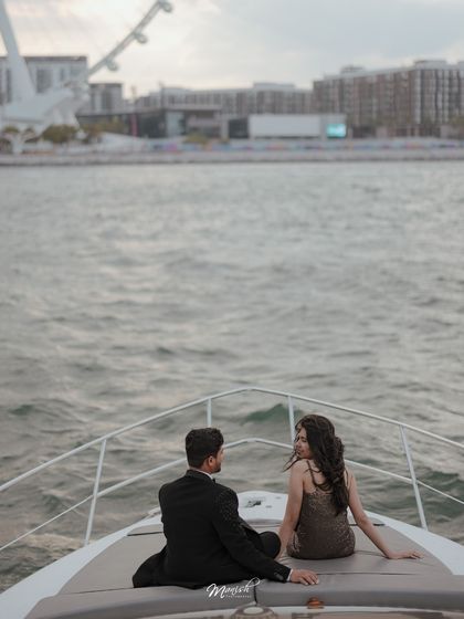 A serene moment on a yacht in Dubai, with the city's iconic skyline in the background. A perfect luxury destination pre-wedding shoot.