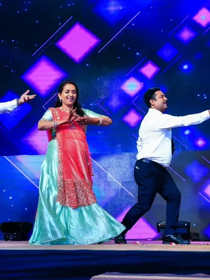 All smiles and fun on stage. We choreograph family dances that are easy to learn and focus on expressions and enjoyment rather than complex steps.