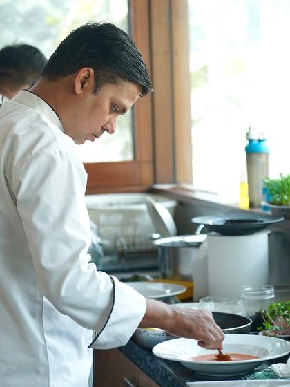 Our chef plating a dish for a New Year's celebration. We offer both easy dining delivery and full catering services to make your parties stress-free and delicious.