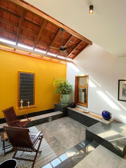 Another angle of the sunlit courtyard, showing how the light streams in, highlighting the textures of the materials. This space is a perfect example of a 'sweet spot' that is both inside and out.