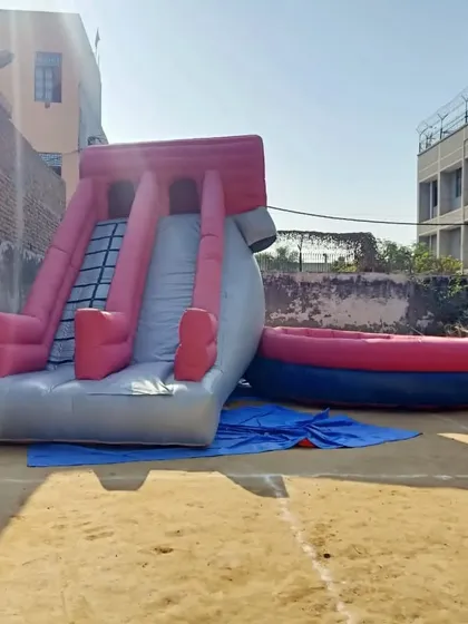 This is a custom inflatable game featuring a steep slide and a separate landing pit. We can design and manufacture unique inflatable games for any purpose.