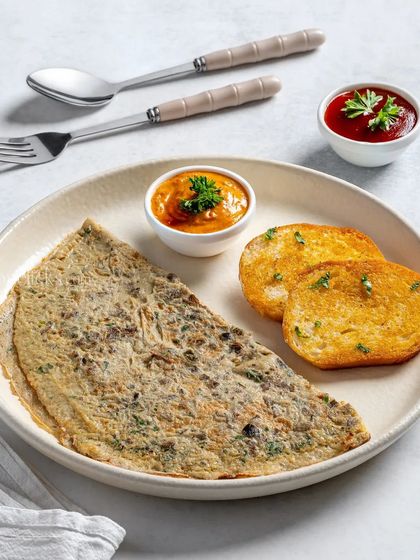 A simple omelette served with two different sauces and toasted bread.