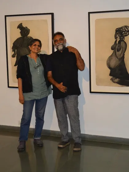 A portrait of artist Shakuntala Kulkarni with her work from the solo exhibition 'Quieter than Silence'. This show featured powerful drawings and reverse paintings that explore the female body and experience.