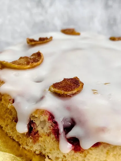 As light as a cloud, with a tangy twist. A close-up of the beautiful glaze and candied lemon on our Lemon Raspberry Cake.
